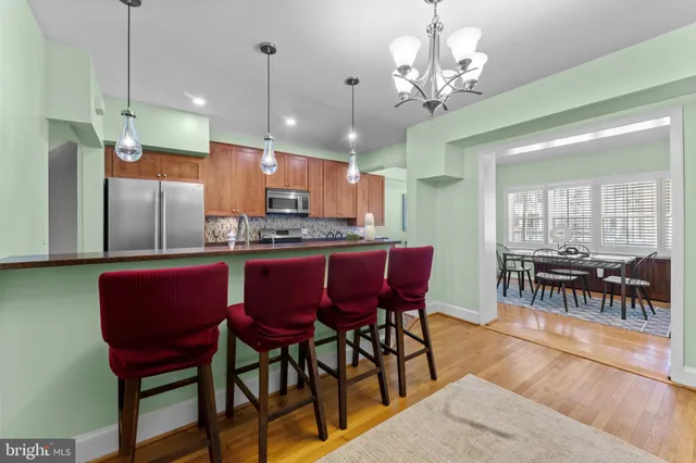 a kitchen with counter top space a sink and stainless steel appliances