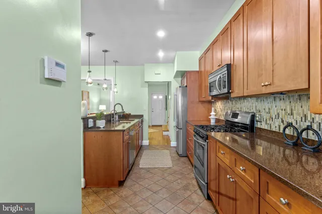 a view of a dining room with furniture and a chandelier