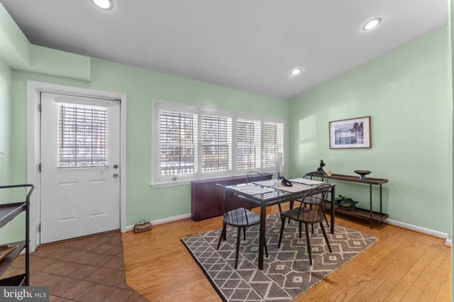 a view of a dining room with furniture and a chandelier