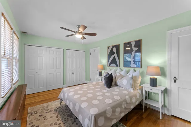 a bedroom with a workspace and a window