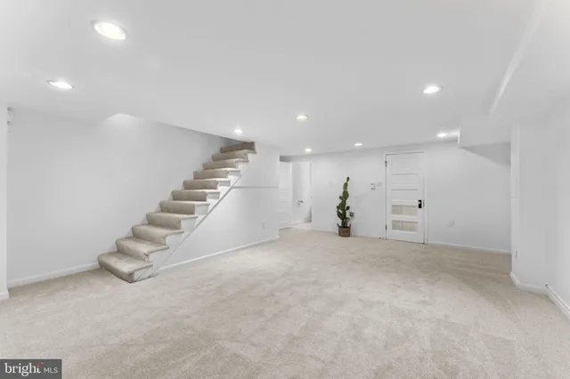 an empty room with a entryway and windows