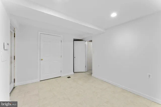 a view of a hallway with wooden shelves