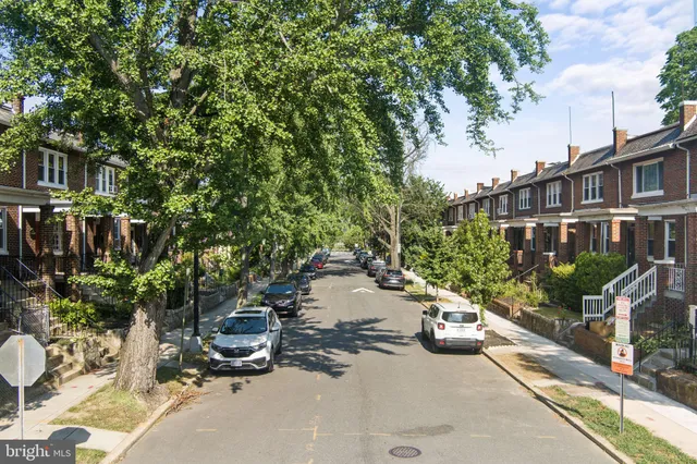 a front view of a residential apartment building with a yard
