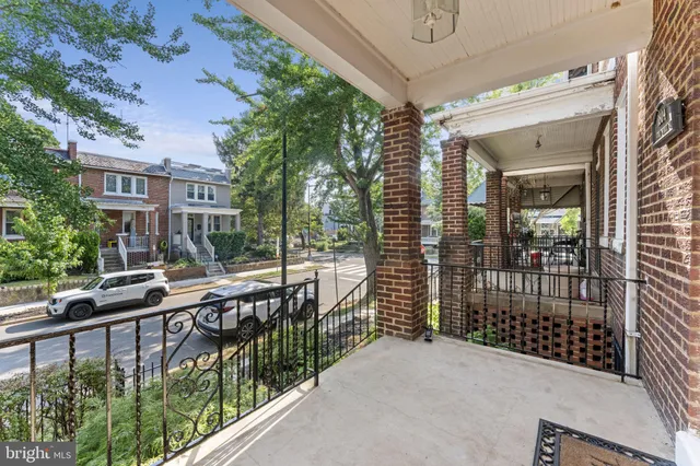 a living room with furniture a chandelier and a dining table