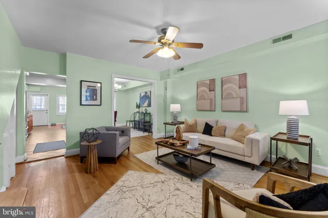 a living room with furniture and wooden floor