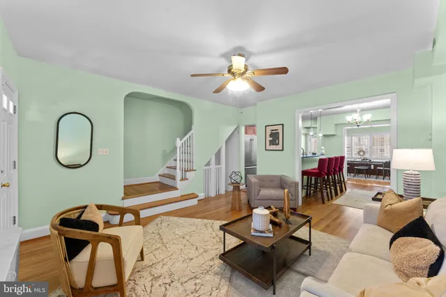 a dining room with furniture a chandelier and window