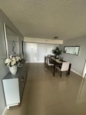 a living room with furniture and flowers
