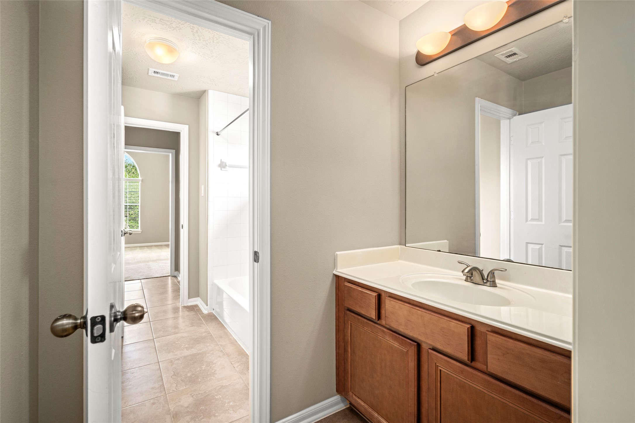5307 Amber Sky Lane Rosharon, TX 77583 - Photo 41 of 50 A stylish single-sink vanity bath with a large mirror and modern lighting offers convenient access from the upstairs hallway.