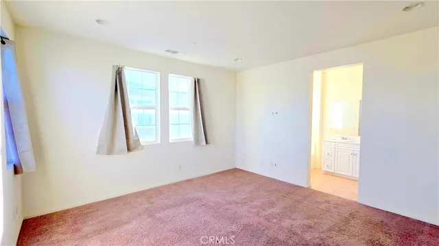 a view of an empty room and a window