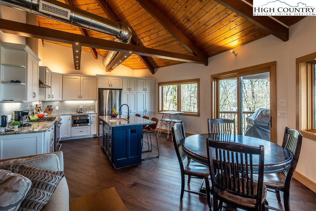 102 Ski Beech Road Beech Mountain, NC 28604 - Photo 14 of 40 a view of a dining room with furniture window and wooden floor