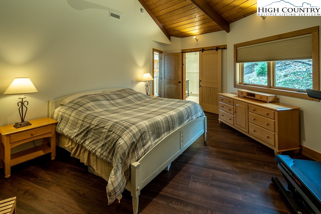 102 Ski Beech Road Beech Mountain, NC 28604 - Photo 20 of 40 a bed sitting in a bedroom next to a window