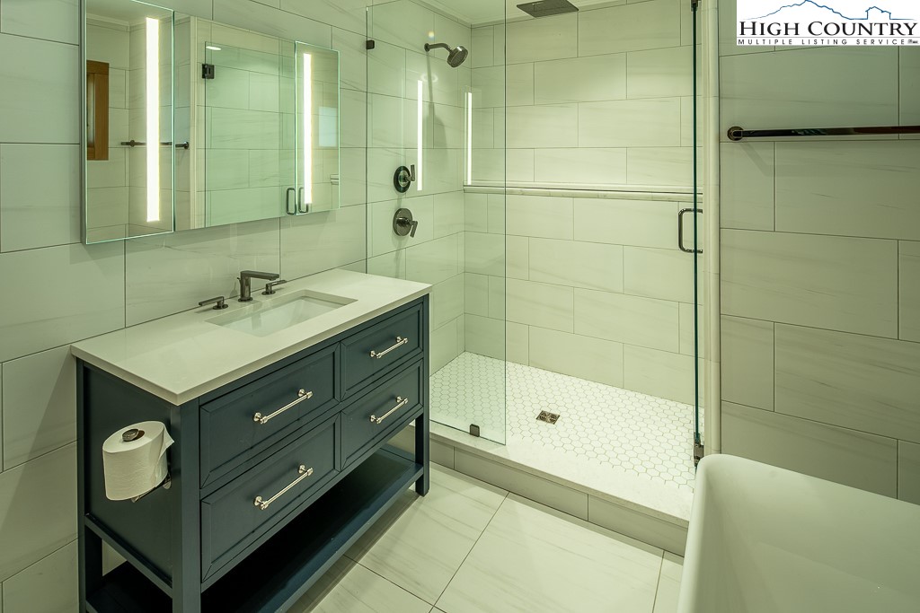 102 Ski Beech Road Beech Mountain, NC 28604 - Photo 22 of 40 a bathroom with a sink and a mirror