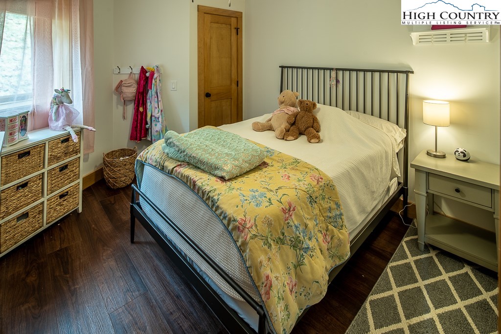 102 Ski Beech Road Beech Mountain, NC 28604 - Photo 25 of 40 a bed sitting in a bedroom next to a window