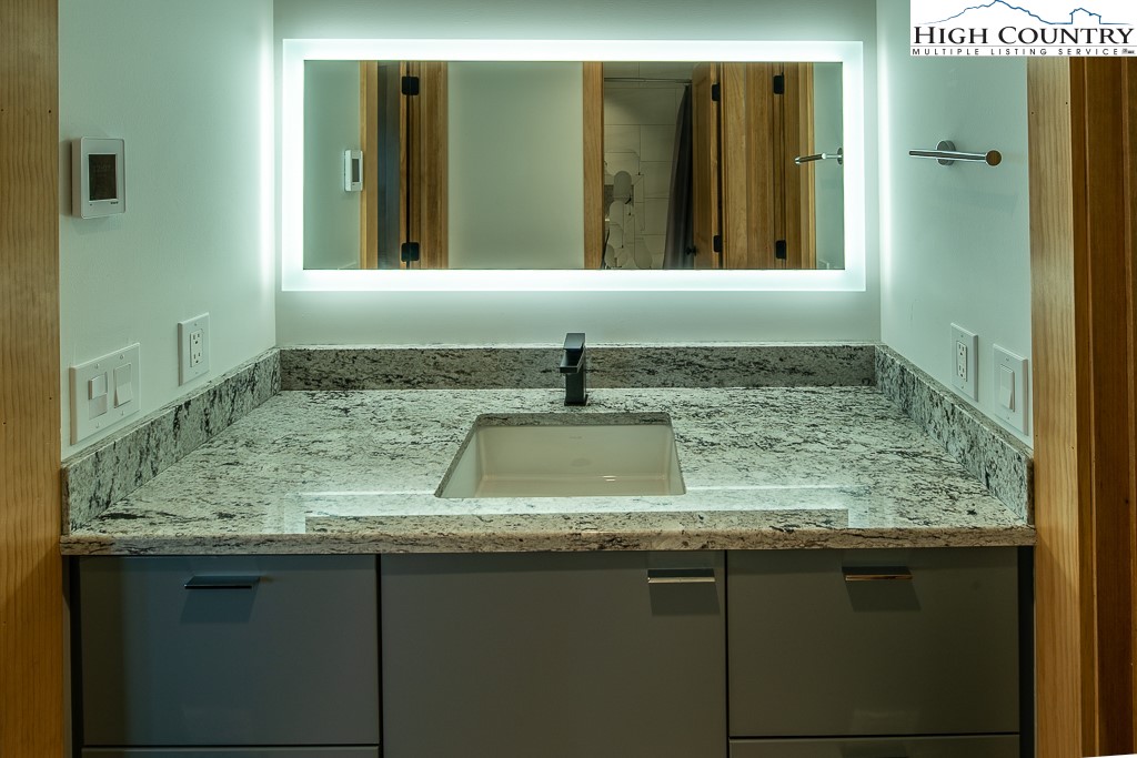 102 Ski Beech Road Beech Mountain, NC 28604 - Photo 30 of 40 a bathroom with a granite countertop sink and a mirror
