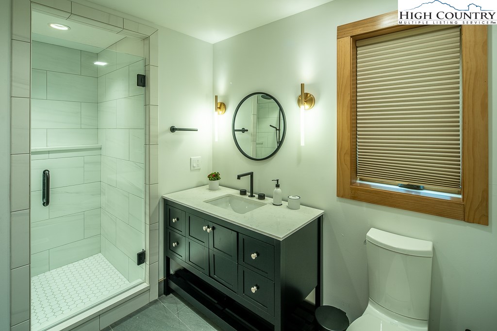 102 Ski Beech Road Beech Mountain, NC 28604 - Photo 32 of 40 a bathroom with a double vanity sink mirror and toilet