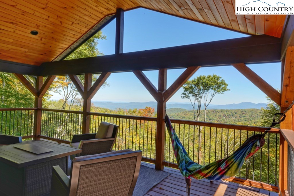 102 Ski Beech Road Beech Mountain, NC 28604 - Photo 6 of 40 a balcony with wooden floor and outdoor seating