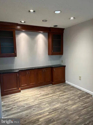 a kitchen with refrigerator a stove and cabinets