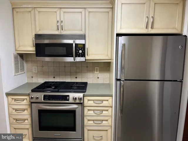 a kitchen with stainless steel appliances granite countertop a sink and a stove