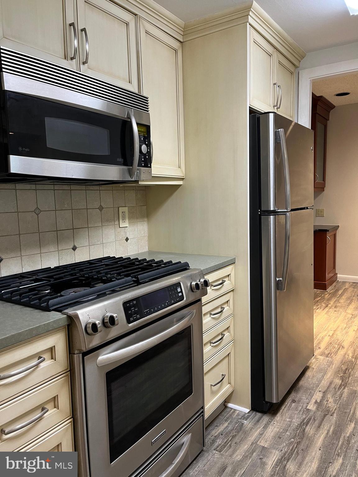 100 West Avenue, Unit 118S Jenkintown, PA 19046 - Photo 16 of 36 a kitchen with stainless steel appliances wooden cabinets and a stove top oven