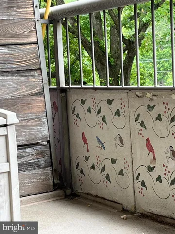 a view of a wooden house with a wooden fence