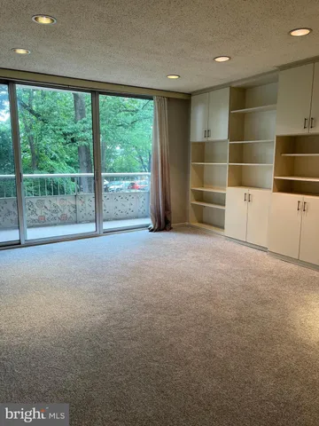 a view of an empty room with empty shelves