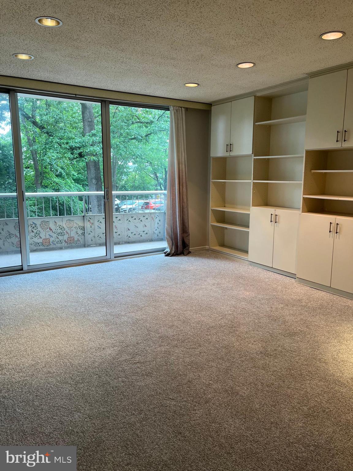 100 West Avenue, Unit 118S Jenkintown, PA 19046 - Photo 4 of 36 a view of an empty room with a window and brick wall