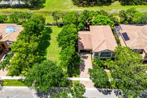 an aerial view of a house with garden space and street view