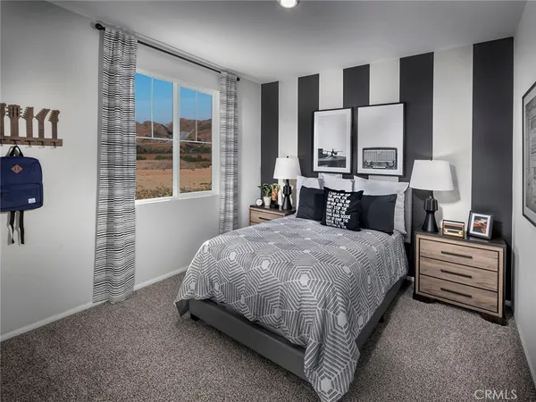 a living room with furniture a flat screen tv and a large window