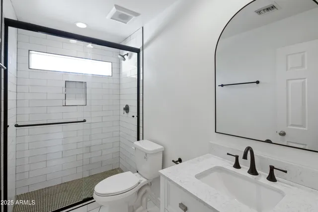 a bathroom with a sink toilet and shower