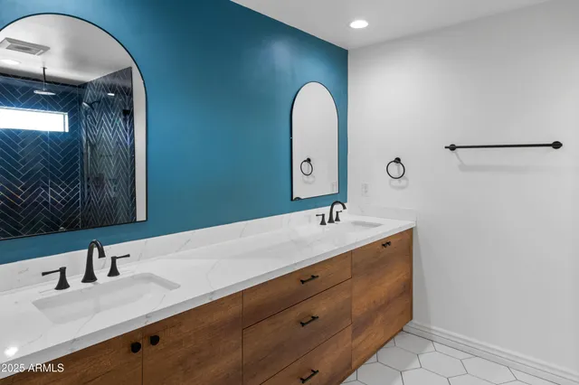 a bathroom with a double vanity sink and a mirror