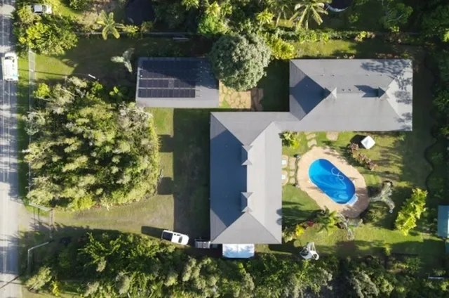 an aerial view of a house with yard swimming pool and outdoor seating