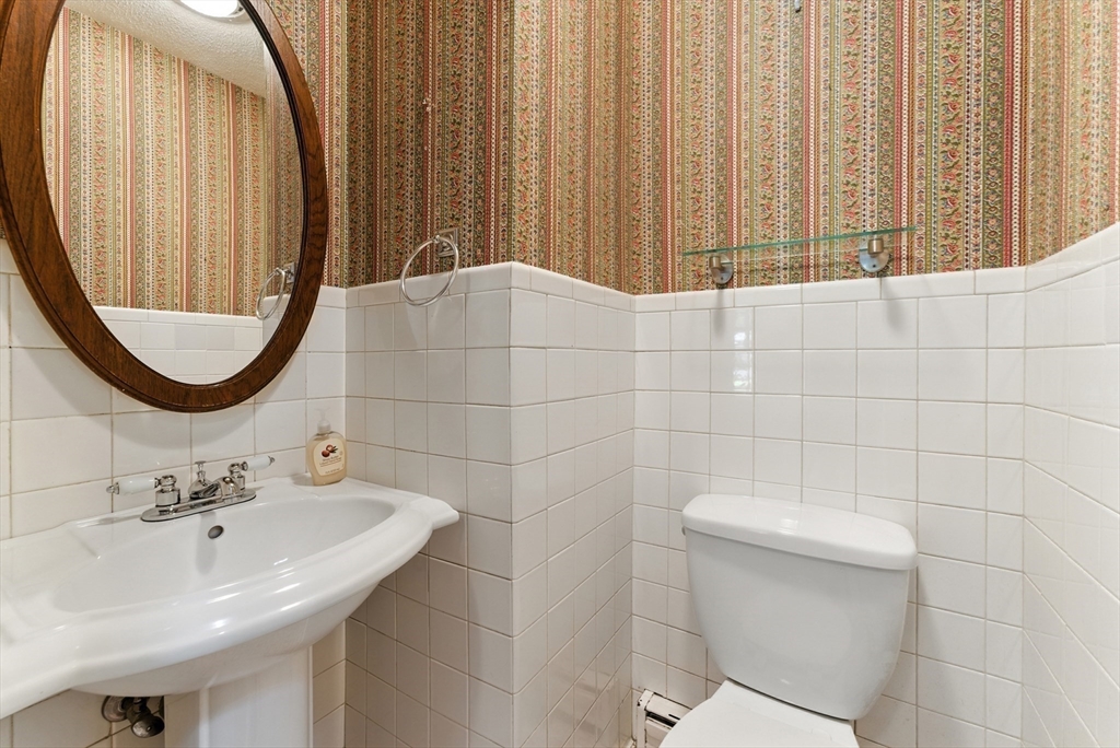 925 Williams Street Longmeadow, MA 01106 - Photo 19 of 38 a bathroom with a sink a toilet and a mirror