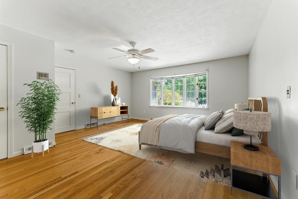 925 Williams Street Longmeadow, MA 01106 - Photo 21 of 38 a bedroom with a bed and a chandelier