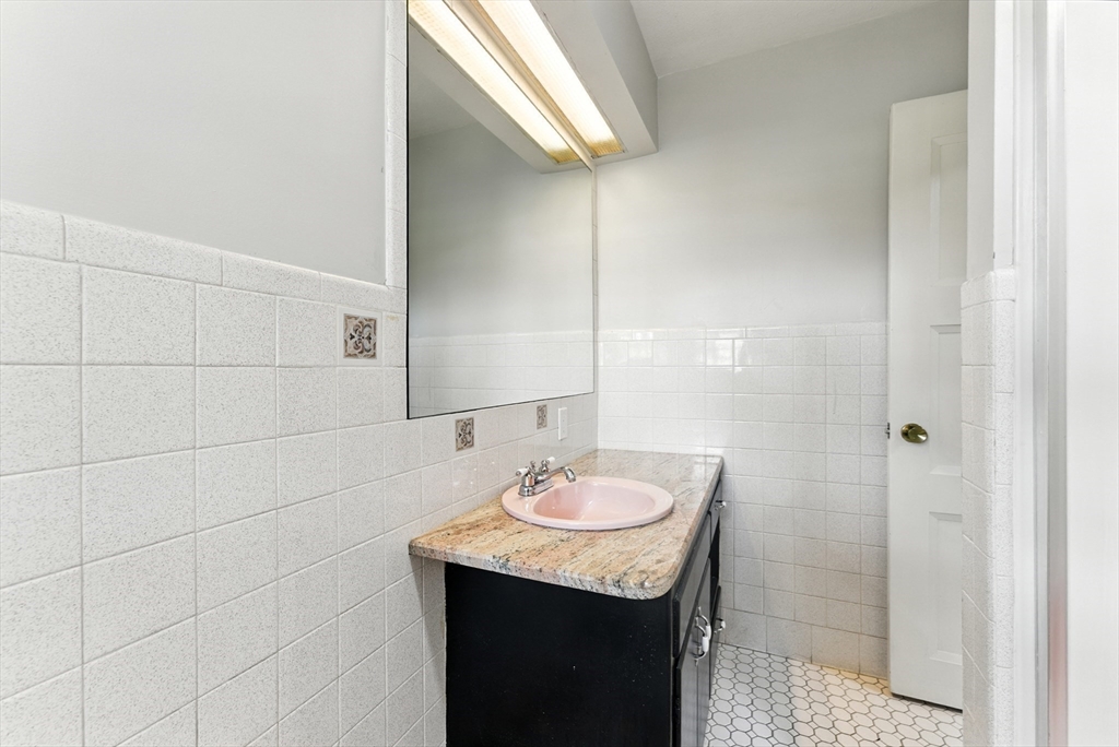 925 Williams Street Longmeadow, MA 01106 - Photo 28 of 38 a bathroom with a granite countertop sink a mirror and a shower