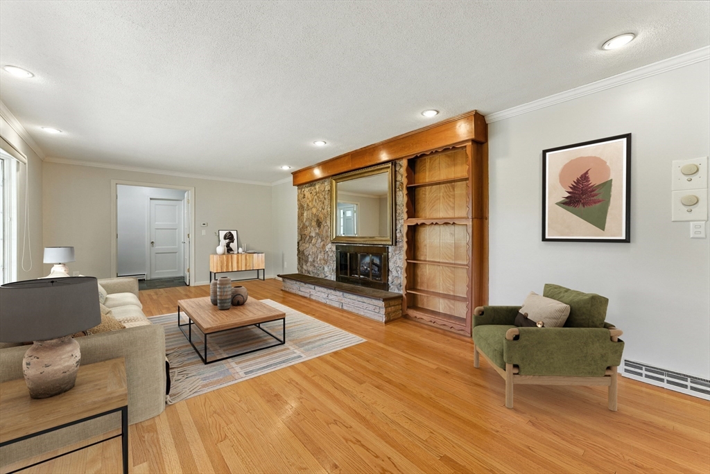925 Williams Street Longmeadow, MA 01106 - Photo 3 of 38 a living room with furniture a fireplace and a flat screen tv
