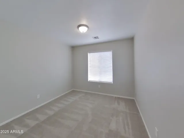 an empty room with closet area