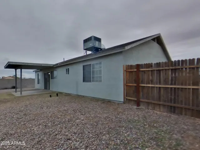 a bathroom with a toilet a sink a mirror a shower a vanity and window