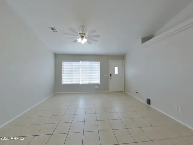 an empty room with a empty space and a ceiling fan