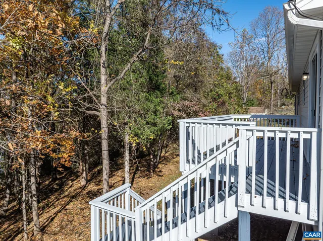 a view of balcony with wooden fence and trees