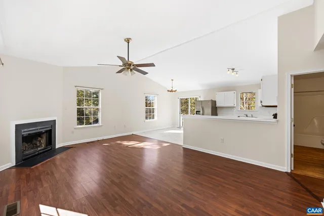 a view of an empty room with a window and fireplace