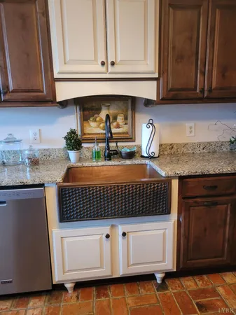 a kitchen with granite countertop cabinets and white appliances