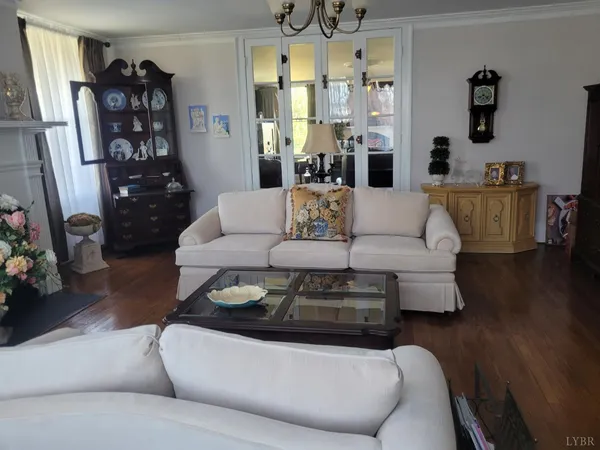 a living room with furniture a couch and wooden floor