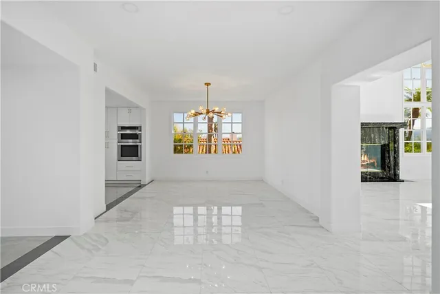 an empty room with window and ceiling fan