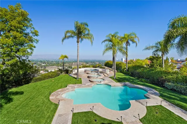 a view of a hallway with wooden floor and a living room