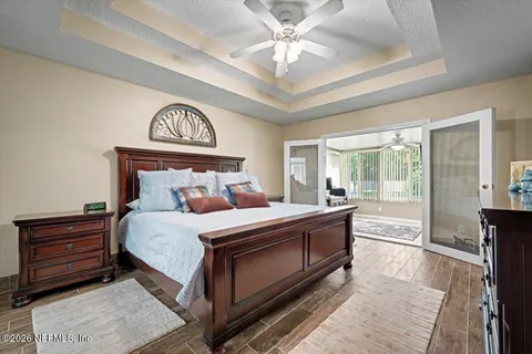 a bedroom with a bed and a chandelier
