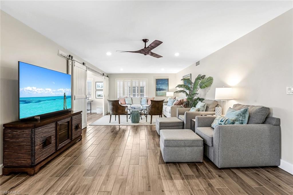 1100 8th Avenue South, Unit H227 Naples, FL 34102 - Photo 11 of 22 a living room with furniture and a flat screen tv