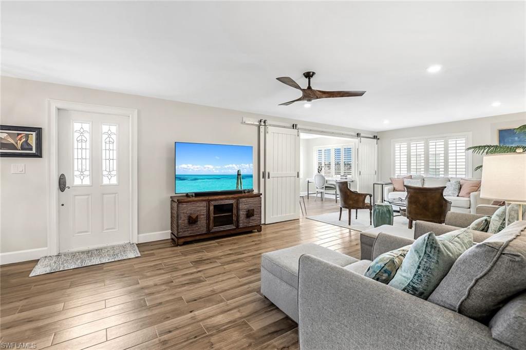 1100 8th Avenue South, Unit H227 Naples, FL 34102 - Photo 12 of 22 a living room with furniture and a flat screen tv