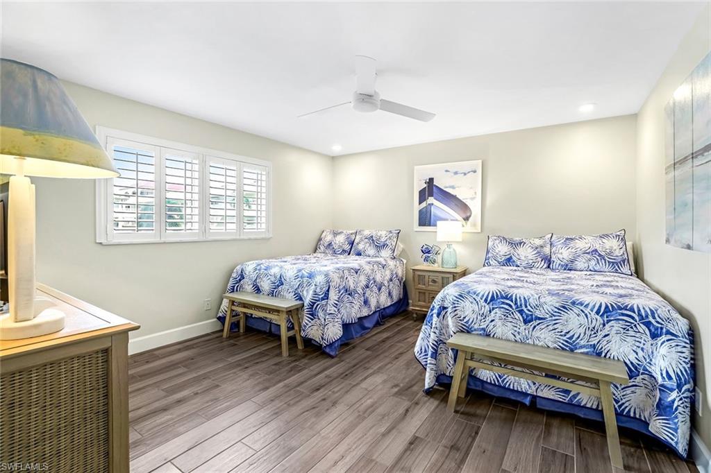 1100 8th Avenue South, Unit H227 Naples, FL 34102 - Photo 16 of 22 a bedroom with a bed and a flat screen tv