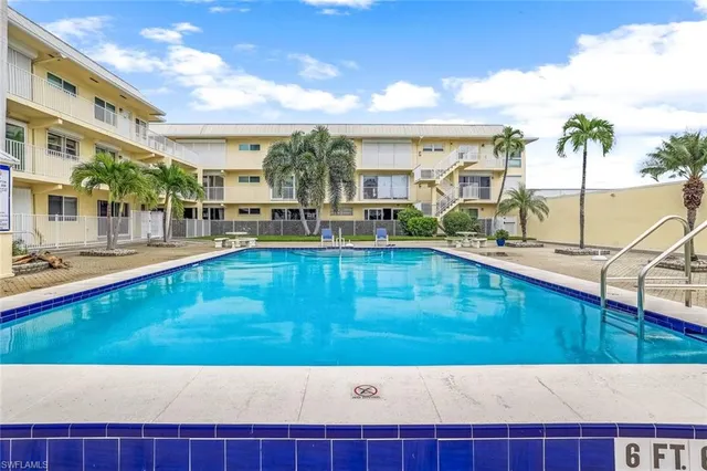 a view of a swimming pool with outdoor seating