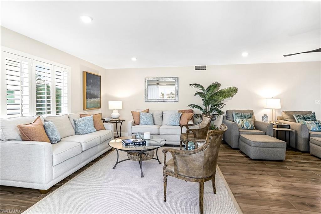 1100 8th Avenue South, Unit H227 Naples, FL 34102 - Photo 3 of 22 a living room with furniture and a large window